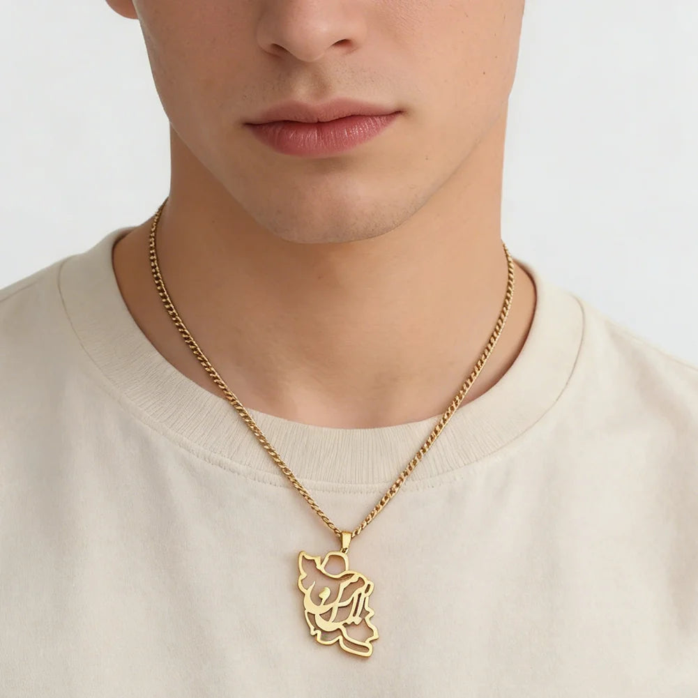 Gold necklace with a pendant worn by a person on a plain background