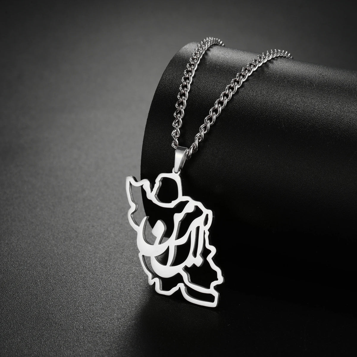 Silver angel pendant necklace on a dark background