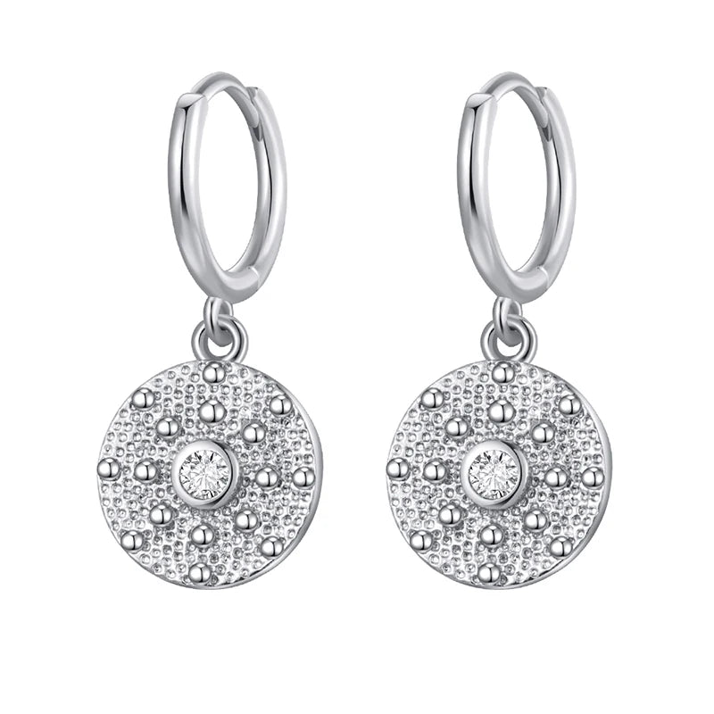 Silver hoop earrings with round pave' stone drops on a white background