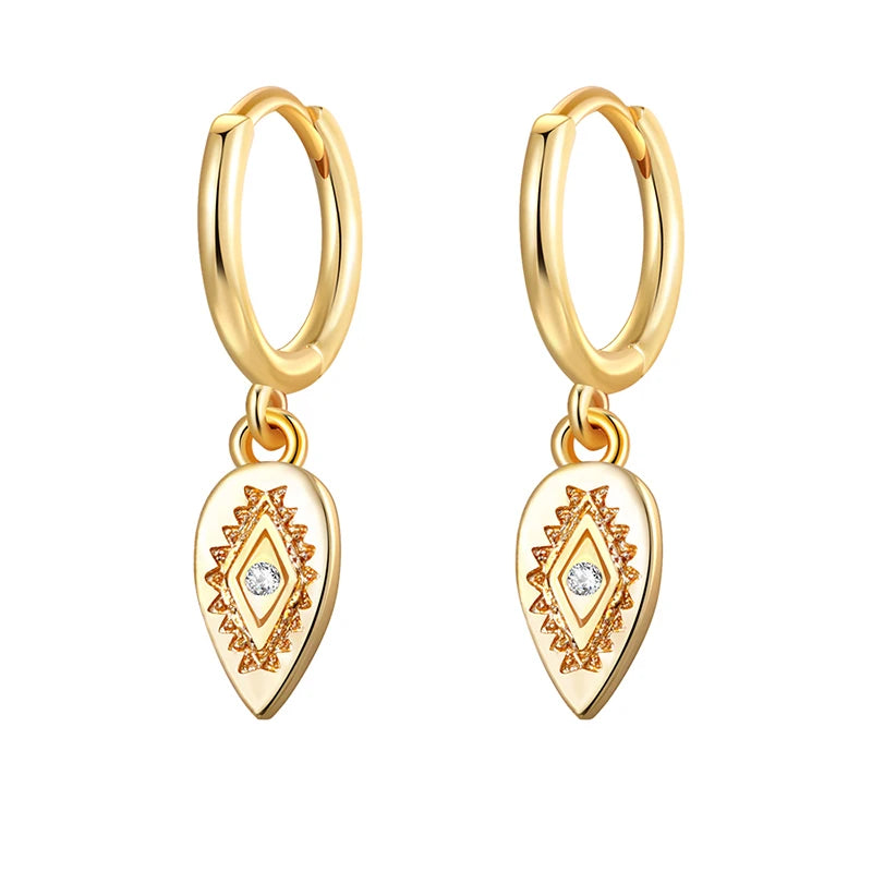 Gold hoop earrings with teardrop-shaped charms on a white background