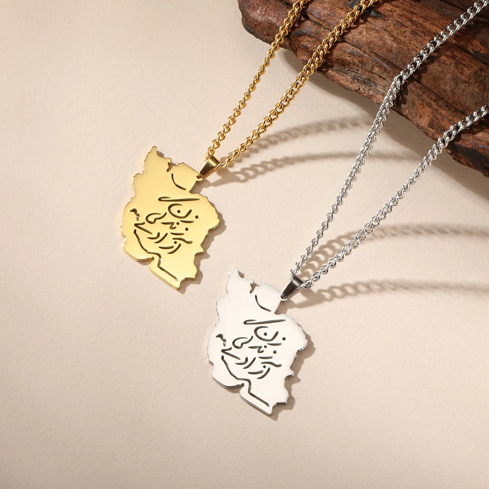 Two custom nameplate necklaces with Arabic calligraphy pendants, one in gold and one in silver, displayed on a beige background with a piece of wood.