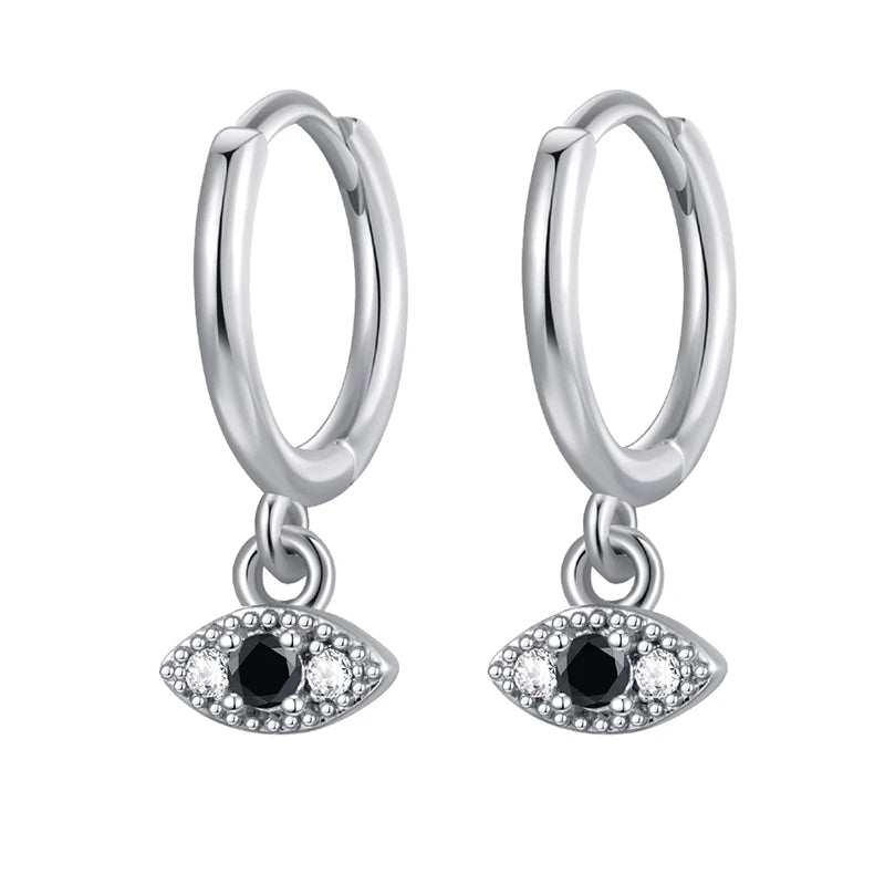 Silver hoop earrings with eye-shaped charms on a white background