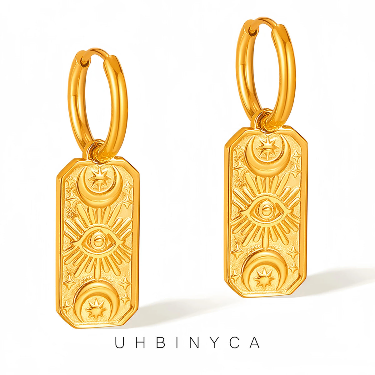 Gold hoop evil eye earrings with intricate designs on white background