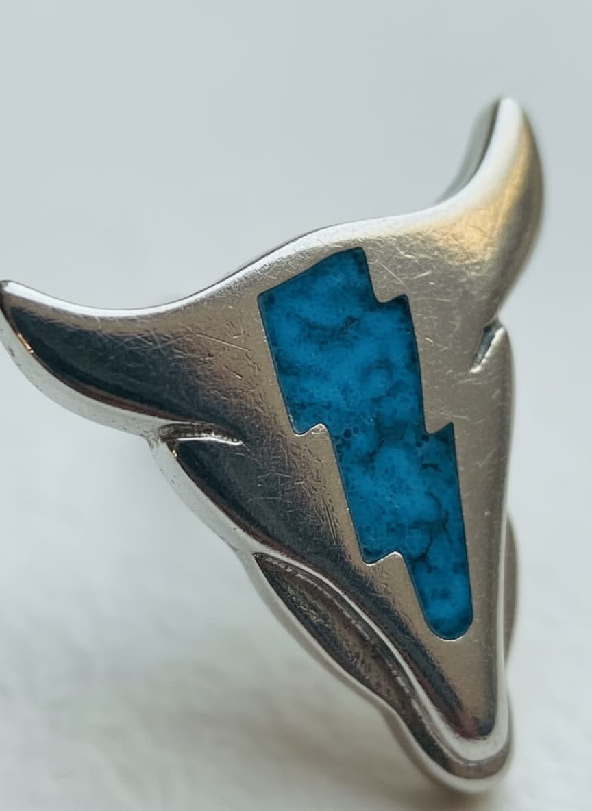 Macro close-up of the cow skull stud with turquoise inlay