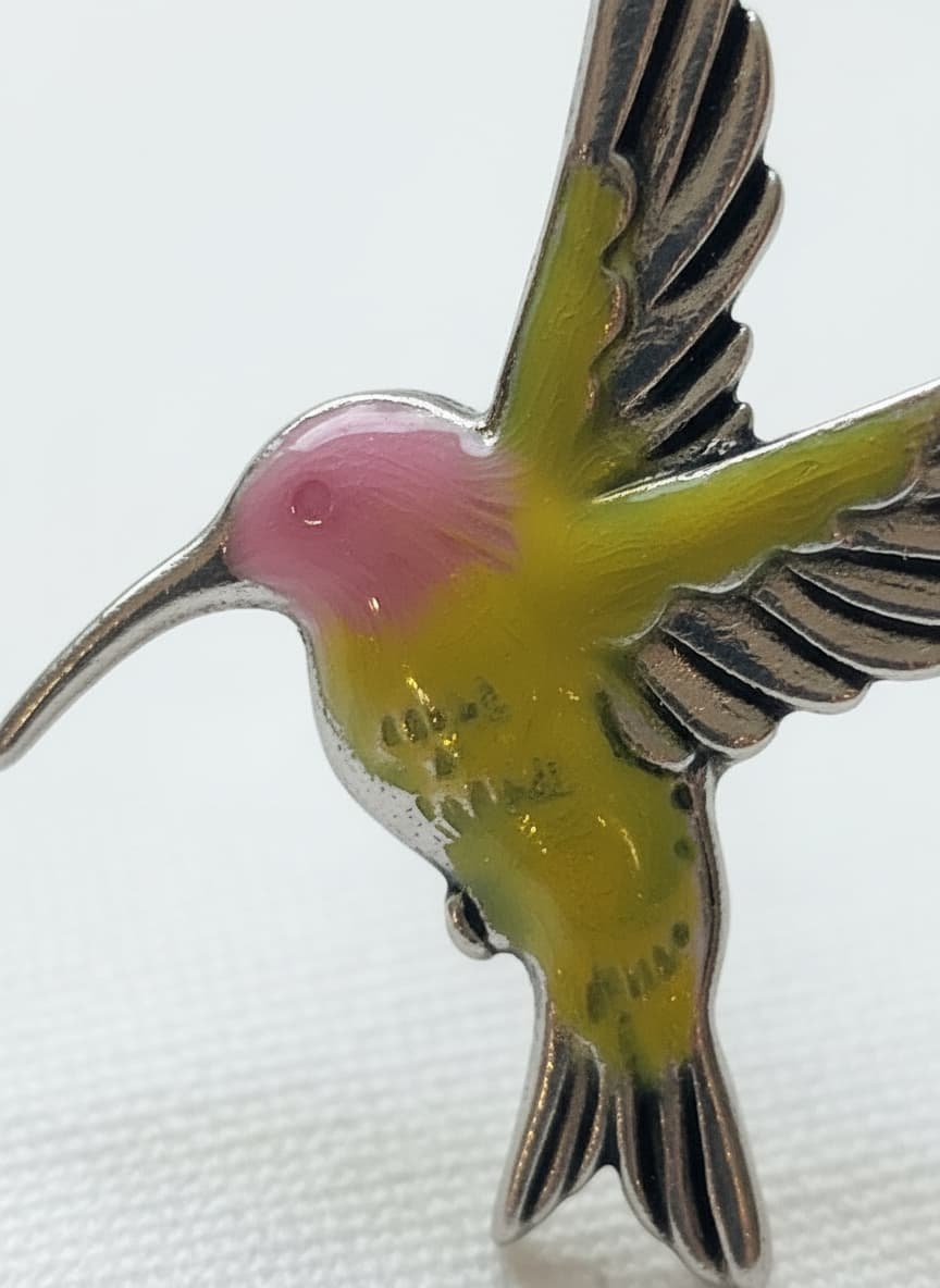 Macro close-up of the hand-painted hummingbird earring