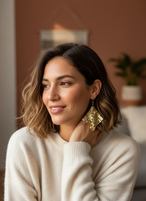 Model wearing gold sequin earrings
