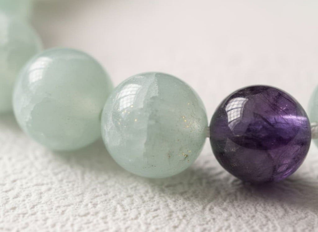 Macro close-up of the jade and amethyst beads