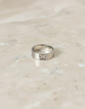 Silver-tone butterfly cutout band ring on marble