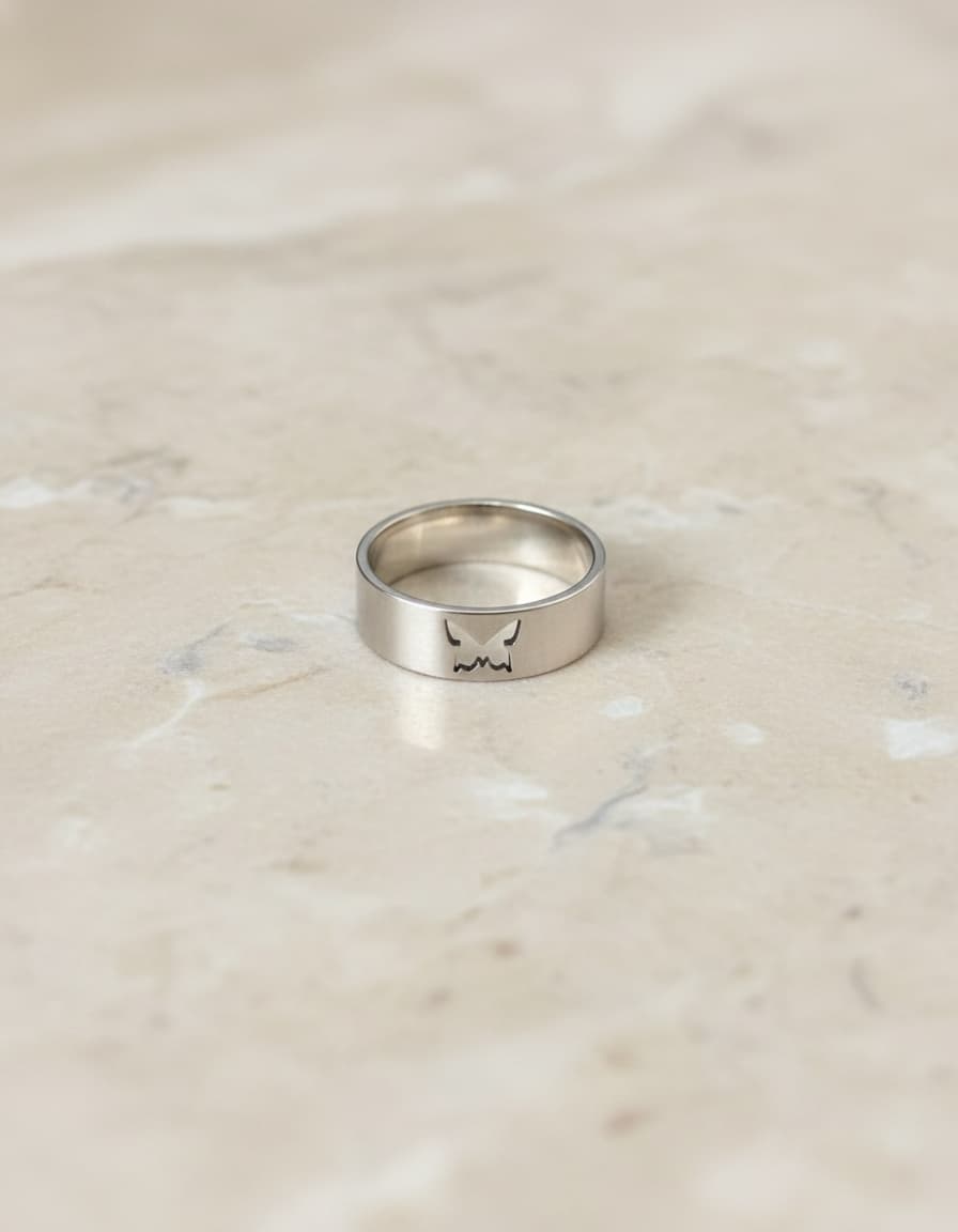 Silver-tone butterfly cutout band ring on marble