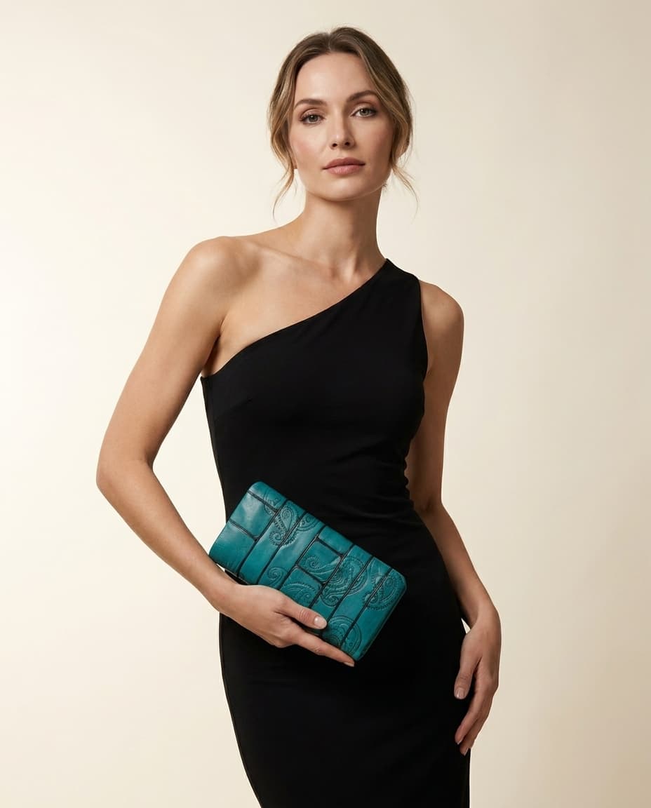 Model holding the teal paisley clutch