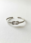 Silver-tone knot bangle on white