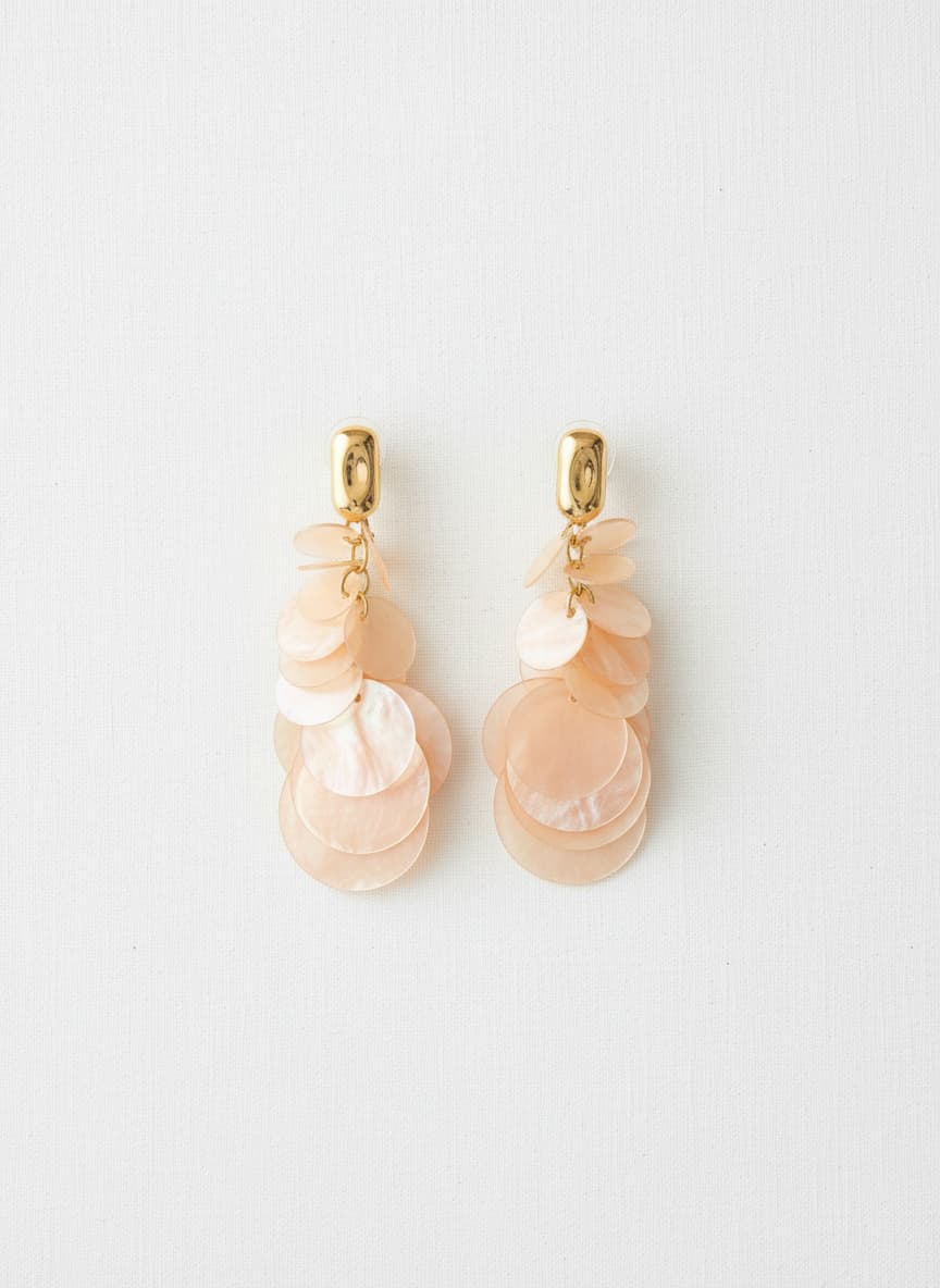 Peach shell disc earrings with gold studs on white