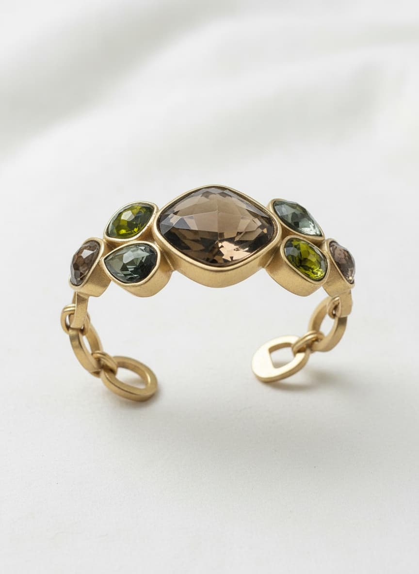 Gold-color bangle with Czech crystal stones on white