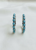 Silver-plated turquoise loop earrings on white