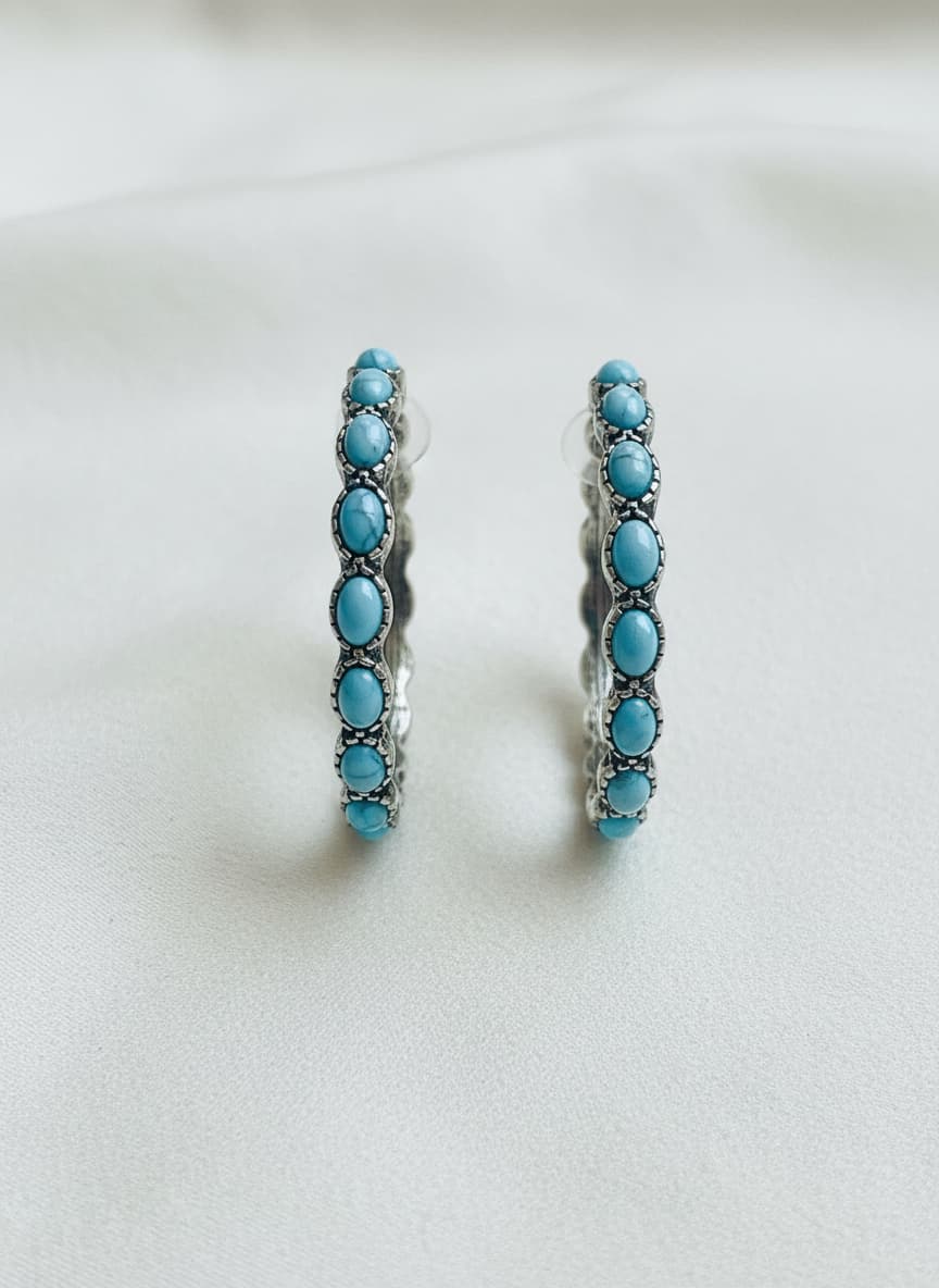 Silver-plated turquoise loop earrings on white
