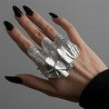 Silver-tone hammered statement ring worn on hand with black nail polish