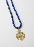 Gold-plated calligraphy pomegranate necklace with sapphire beads on white