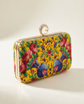 Yellow floral velvet box clutch on white
