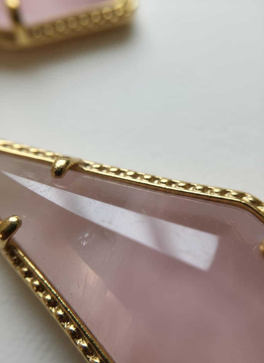 Macro close-up of the pink Czech glass stone and gold setting