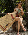 Woman wearing a cream shawl with Persian manuscript print
