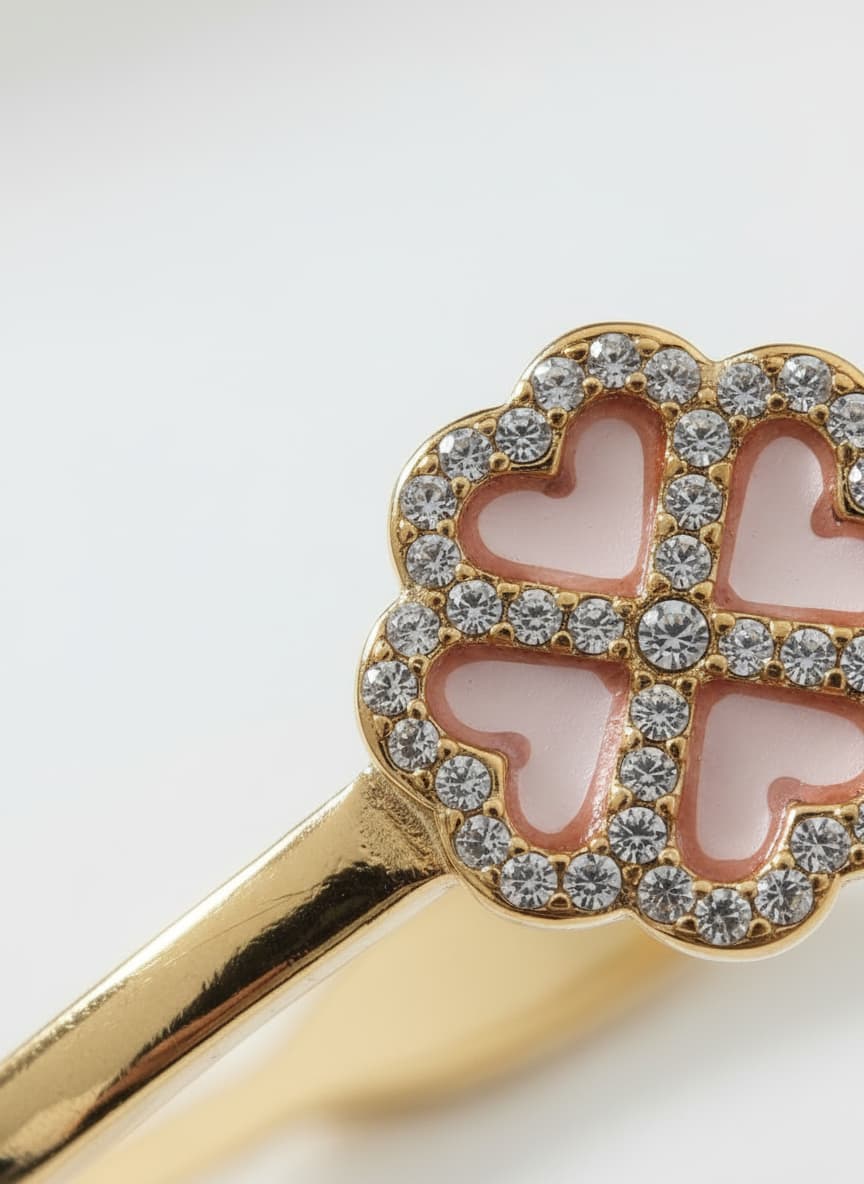 Macro close-up of the floral motif on the gold-plated bangle