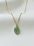 Green jade tree-of-life necklace on white