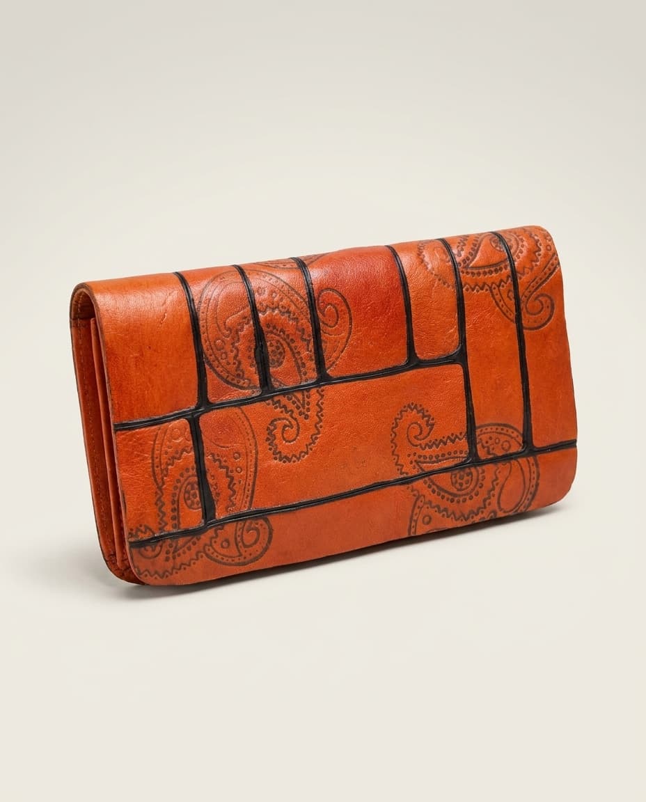 Orange paisley embossed clutch on white