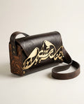 Brown leather crossbody bag with calligraphy bird ornament