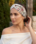 Model wearing a floral and calligraphy twisted headband