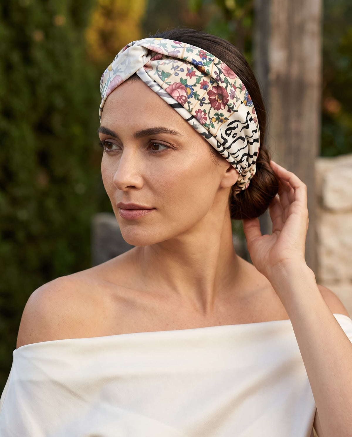 Model wearing a floral and calligraphy twisted headband