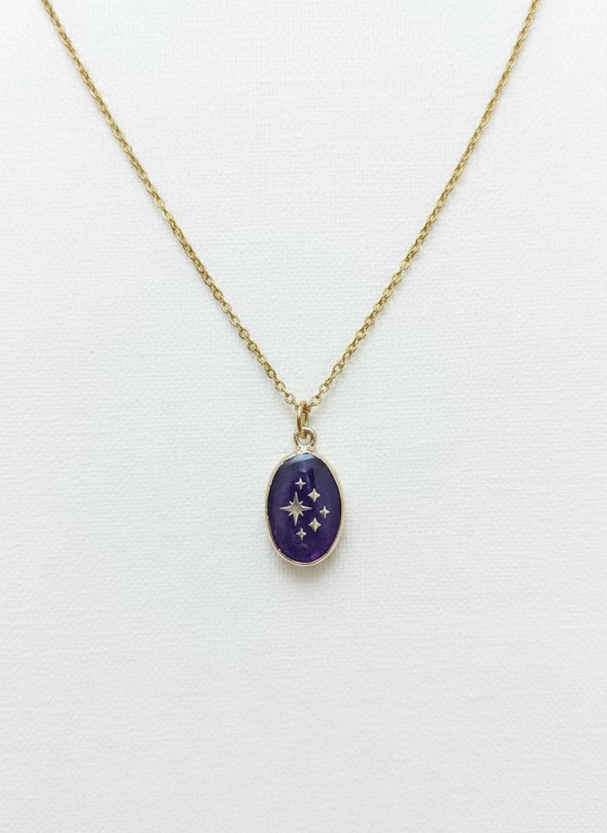 Gold necklace with purple amethyst star pendant